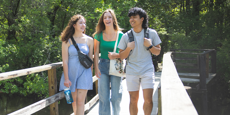 students pictured walking on a dock lauging