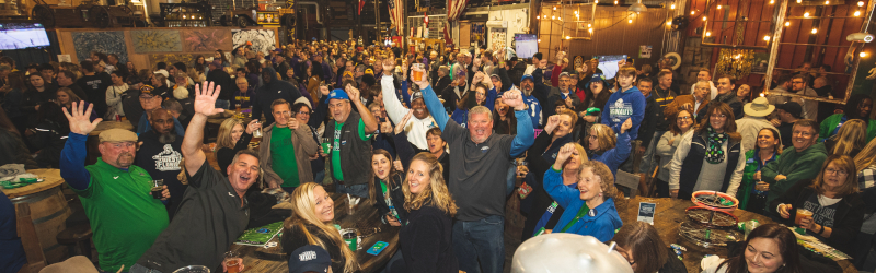 a large group of alumni cheer during the 2019 football national championship pep rally in Texas