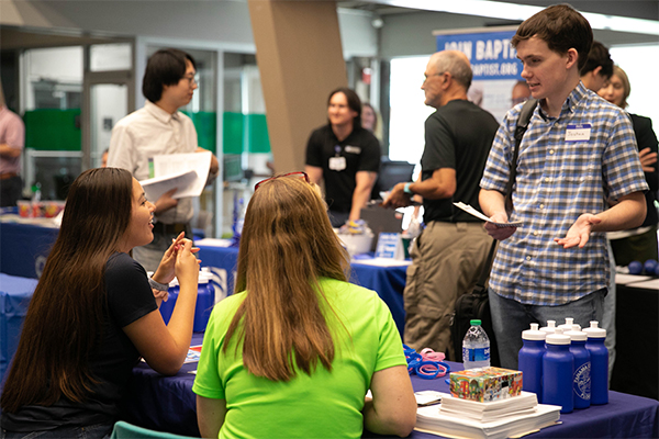 Student interacting with employers at a career event