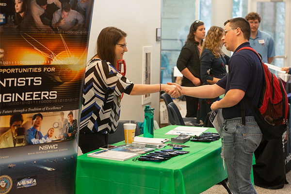 Employer engaging with a student at a career fair