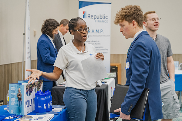 Employer engaging with a student at a career fair
