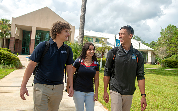 Three students walking to class at UWF Emerald Coast campus.