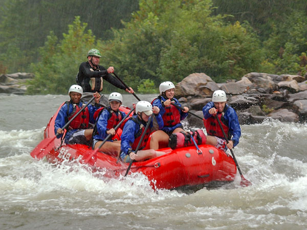 Students in a raft, navigating rapids