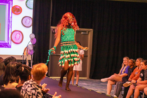 student walking down runway of project inspired dress