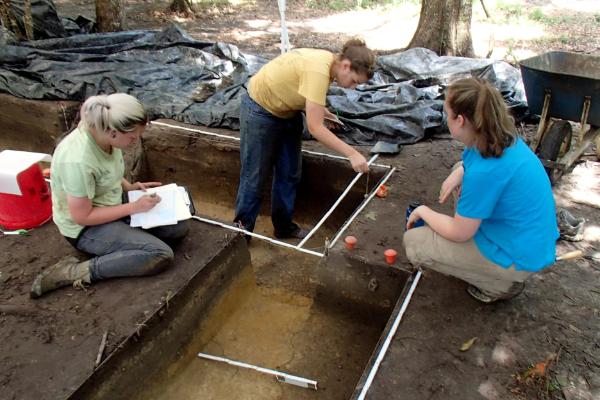 Graduate and Undergraduate students excavate features at an archaeological site in the Pensacola Area