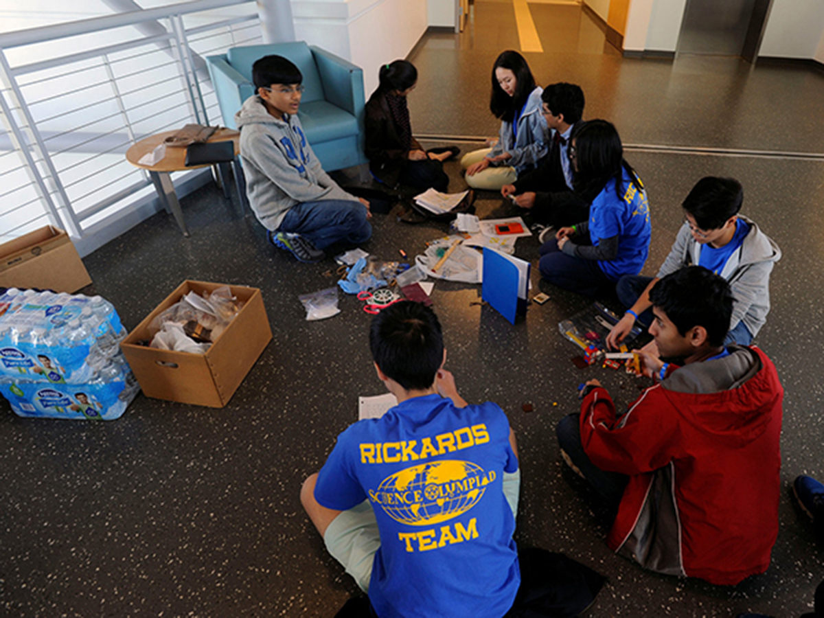 Members of the Rickards High School team of Tallahassee relax Saturday during the Northwest Florida Regional Science Olympiad Competition at the University of West Florida.