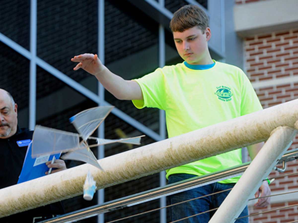 Anders Foster of Gulf Breeze Middle School, drops his egg during the Rotor Egg Drop competition Saturday during the Northwest Florida Regional Science Olympiad Competition at the University of West Florida.