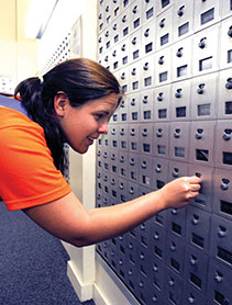 Business & Auxiliary Services photo of student opening post office box