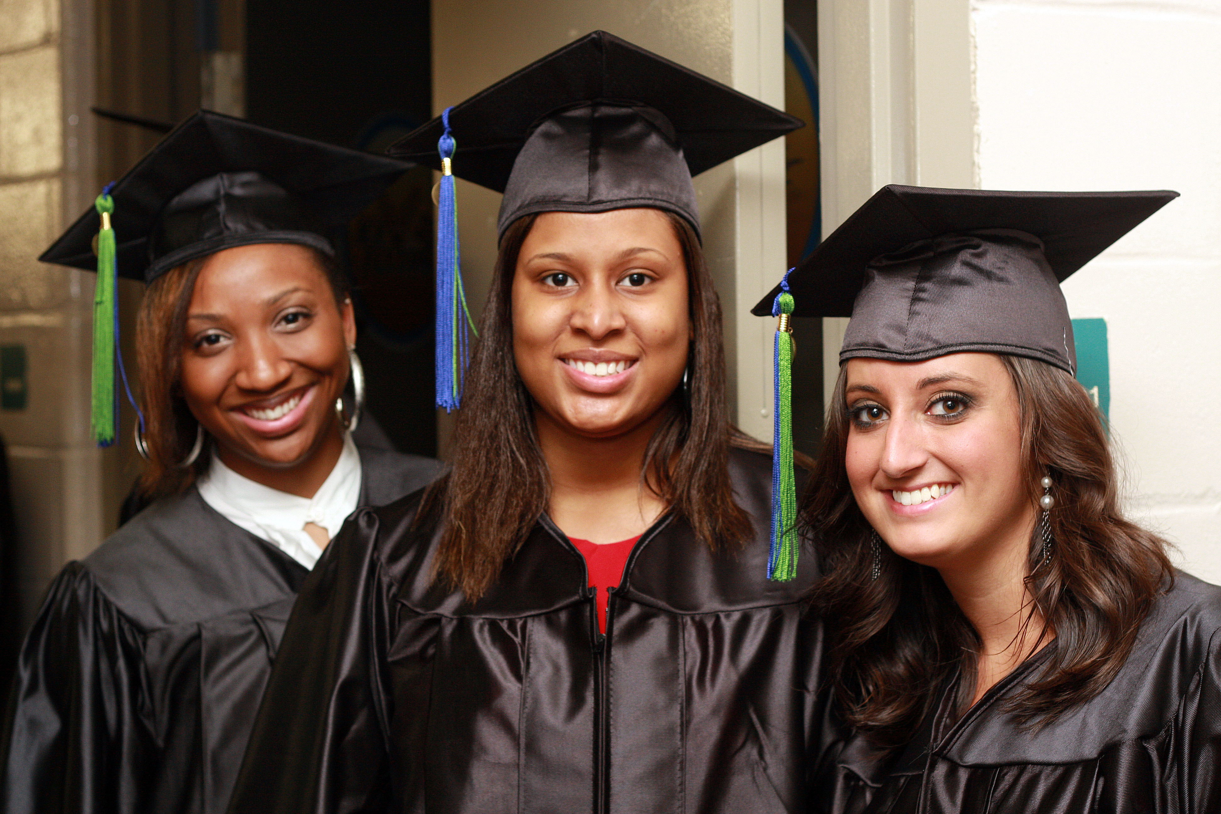 Three graduating students in regalia