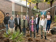 Carrie Fonder with students in front of artwork.