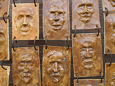 An art piece displaying panels of different faces.