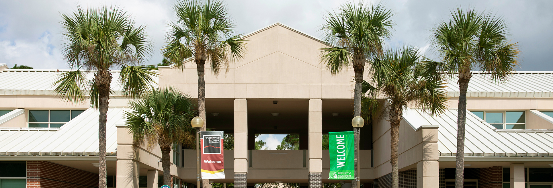 Welcome Building surrounded by palm trees