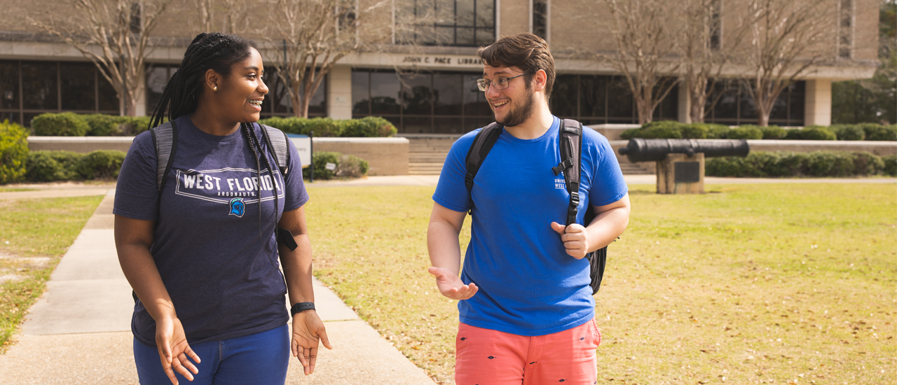 Jumbotron - 2 students walking and talking