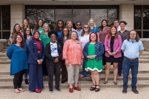A group of employees standing on stairs outdoors