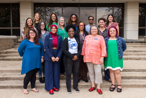 A group of employees standing on stairs outdoors