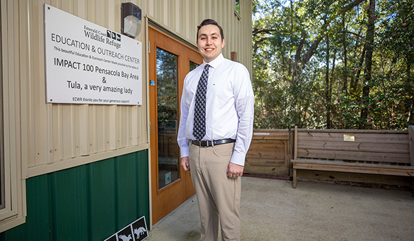 James Barnes GIS grad in front of Wildlife Rescue Building