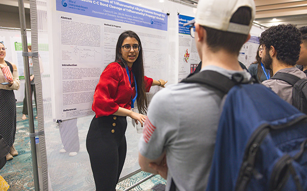 An Honors student presents a chemistry thesis at the UWF Student Scholars Symposium 2025.
