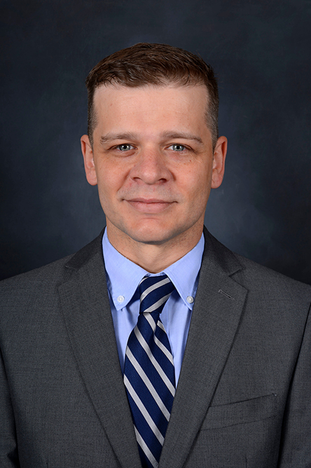 Christophe Lizen indoor headshot wearing professional suit and tie attire.
