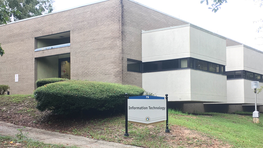Building 79 on the UWF Pensacola campus with signage in front of the building that states 79 Information Technology.