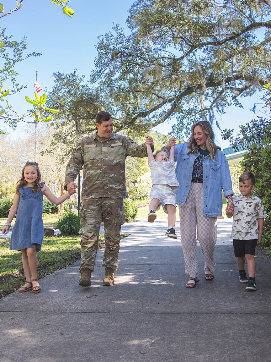 A UWF military family walks through campus.