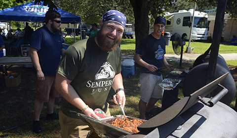 Volunteers cook at a UWF event.