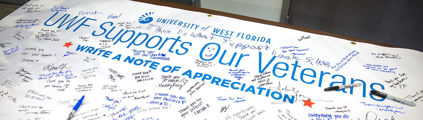 A UWF Supports Our Veterans banner shows signatures of appreciation