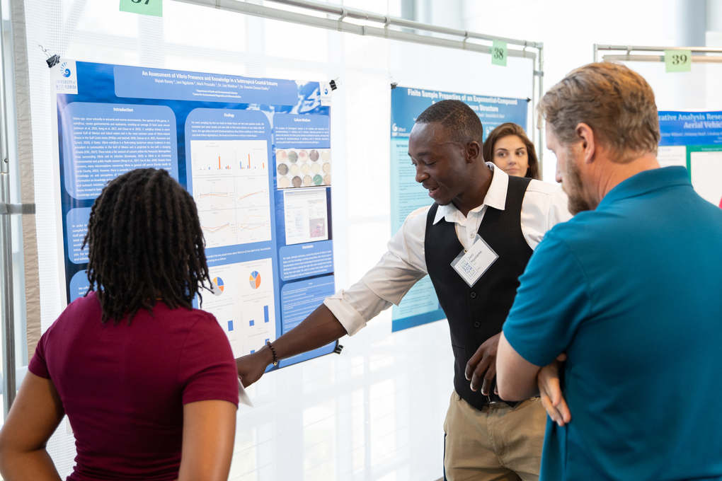 Student presenting at symposium to other students