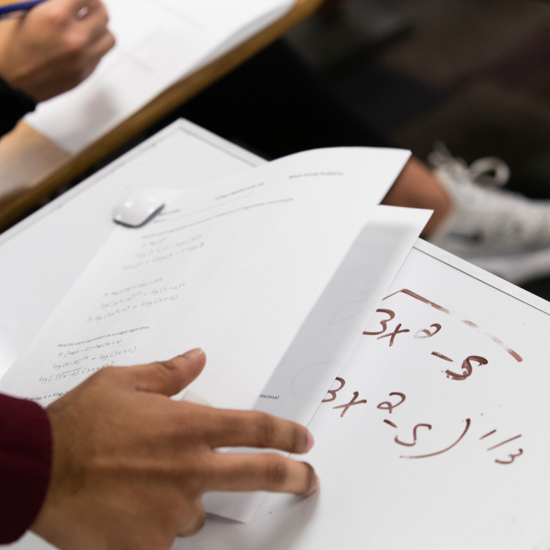 math fomulas on a whiteboard with a worksheet on top