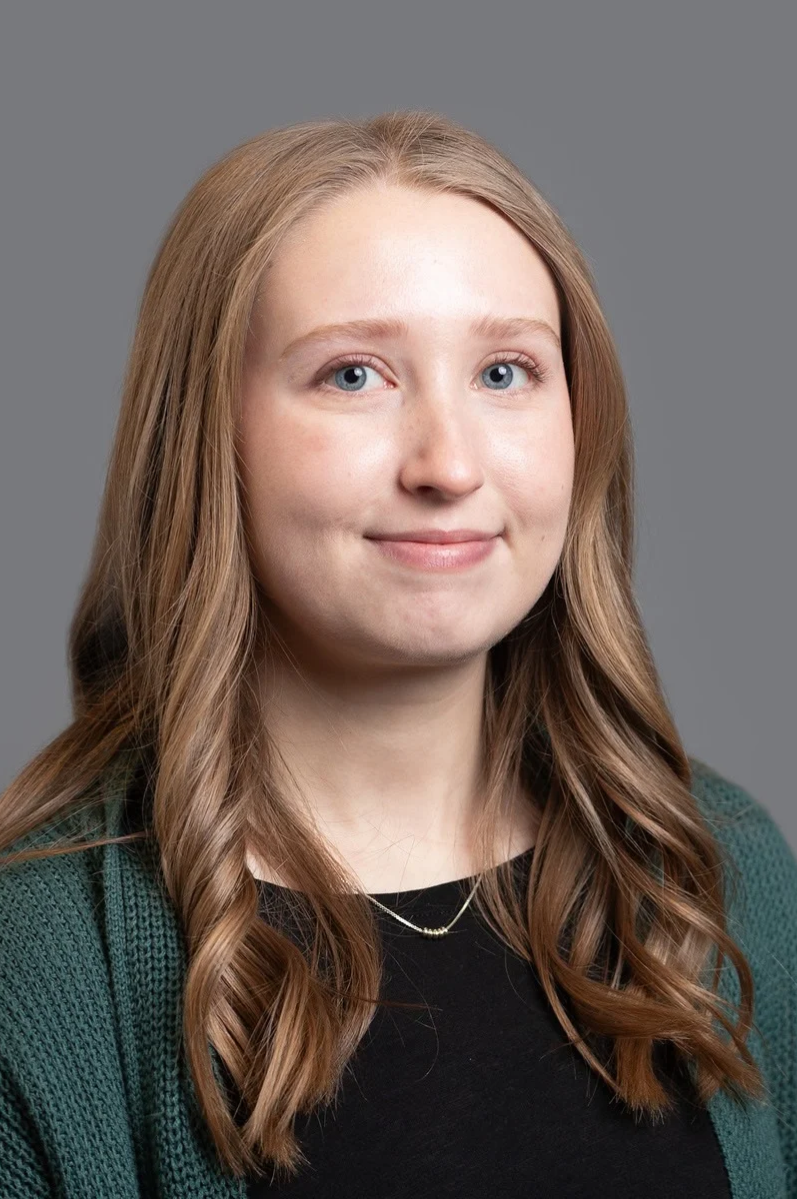 Professional headshot of Meredith against a neutral background