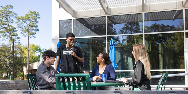 students sitting together at outside seating area