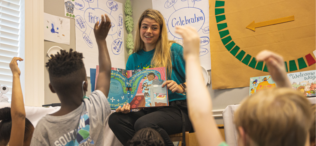 A UWF student reads books to young children