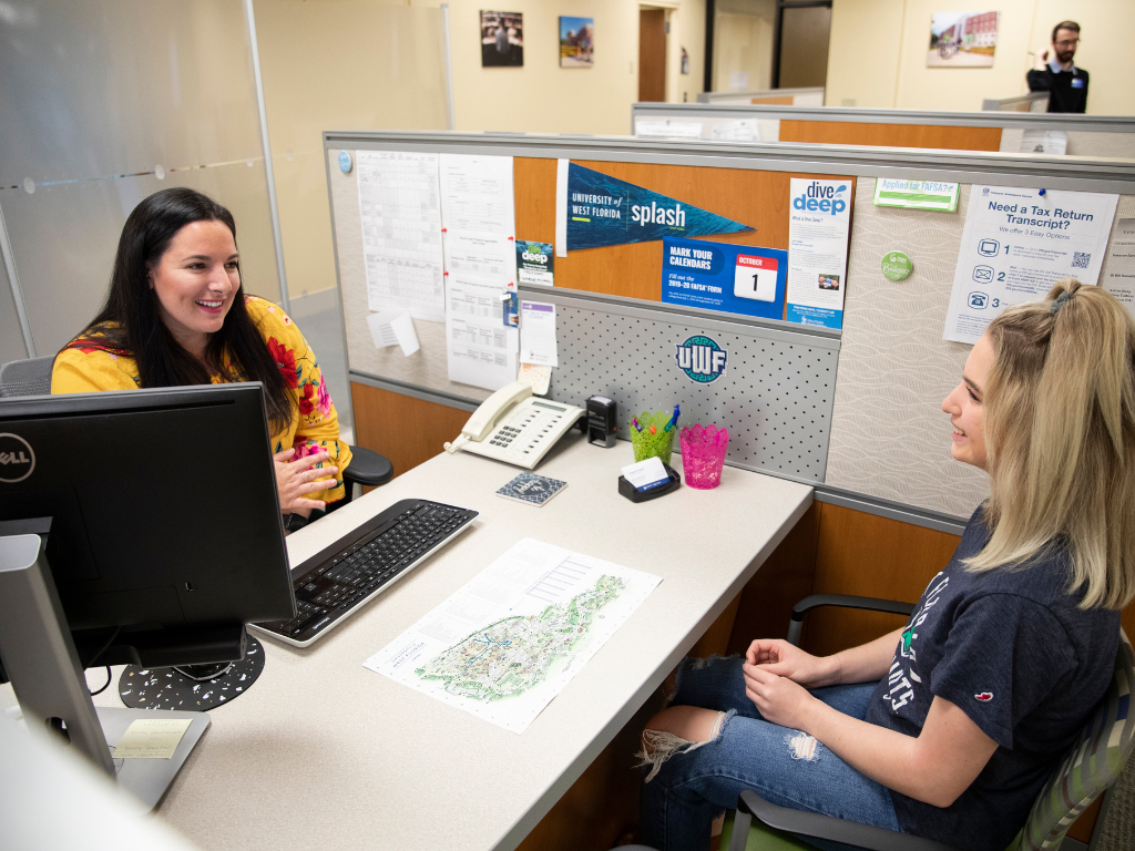 An acadmic advisor helps a student registering for classes