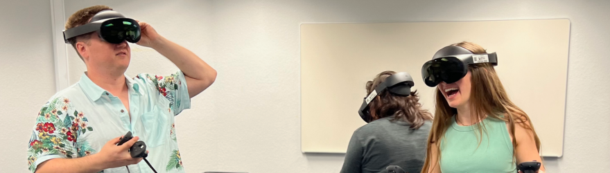 Three students use VR helmets.