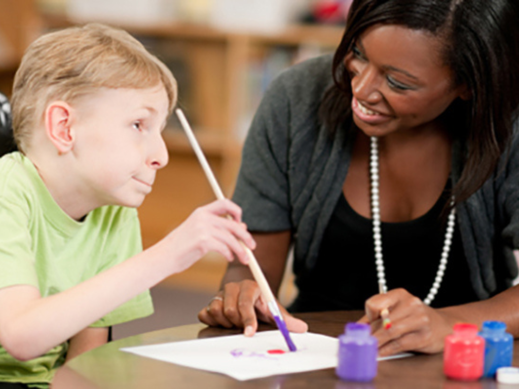 A teacher assists a student with special needs