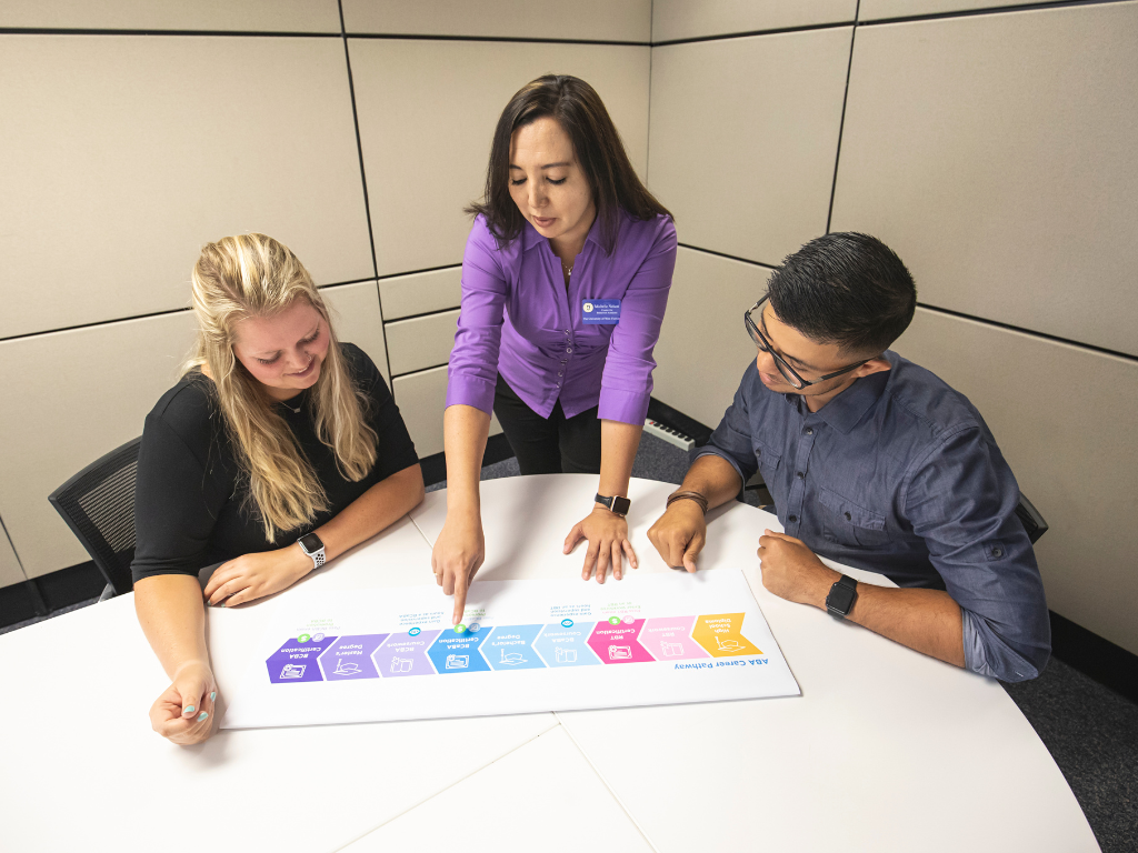 UWF staff speaks to two students about the ABA program