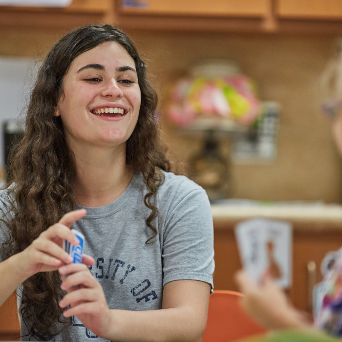 A UWF students plays cards with a child at the ERCCD