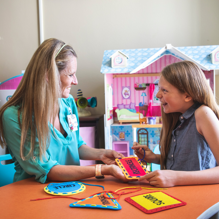 A professional educator works with a student in a one on one session