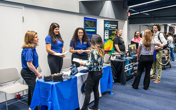 students at a career fair with employers