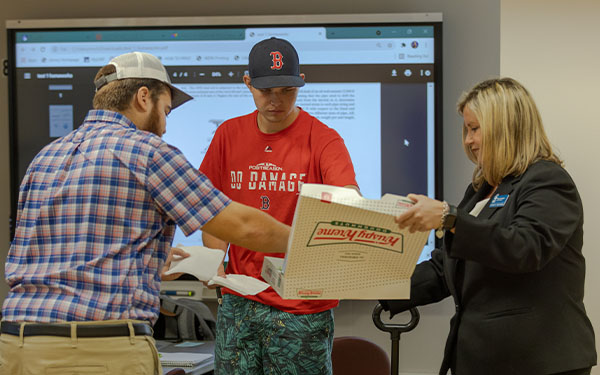 dean delivering donuts to students