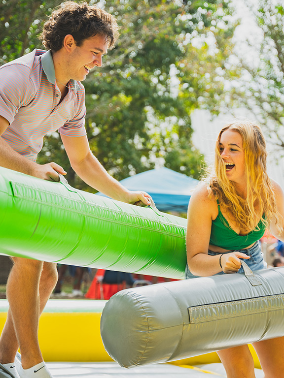 students playing on an event attraction