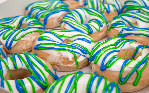 A picture of blue and green glazed donuts