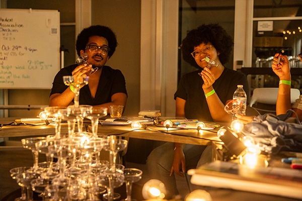 students sitting at a table with glasses and lights