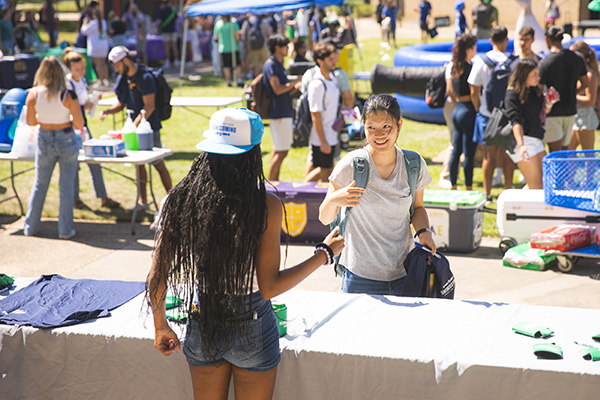 a student getting homecoming merch