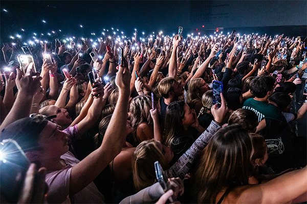 crowd of students with phone lights