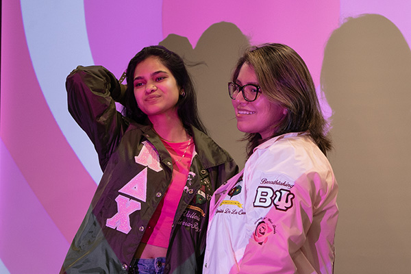 students posing with a heart shaped photobooth