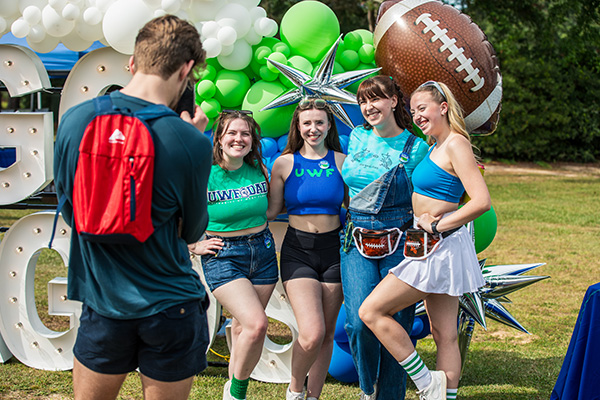 students posing for a picture at hoco tailgate