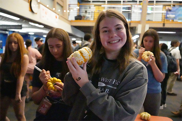 student holding a pumpkin