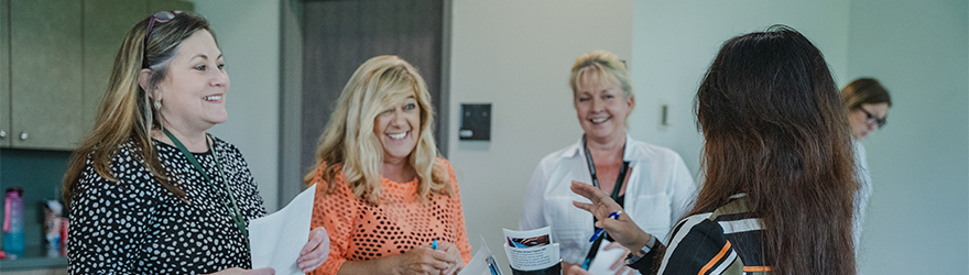 Employers speaking to a student at a career fair