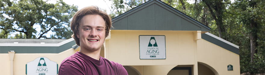 Student posing outside of their internship workplace