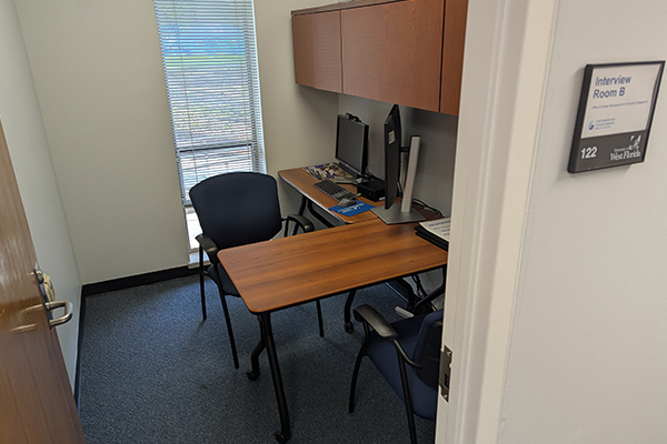 empty desk and chair with computer